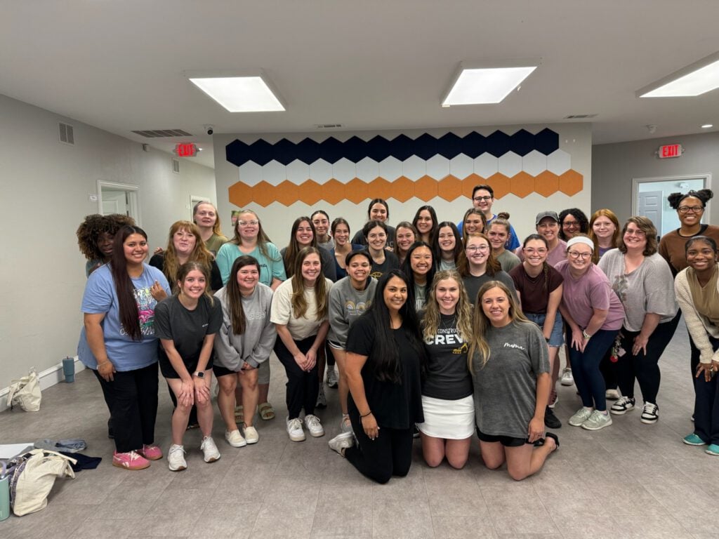 Team of therapists and staff at Allison’s Therapy Corner standing together inside the clinic.