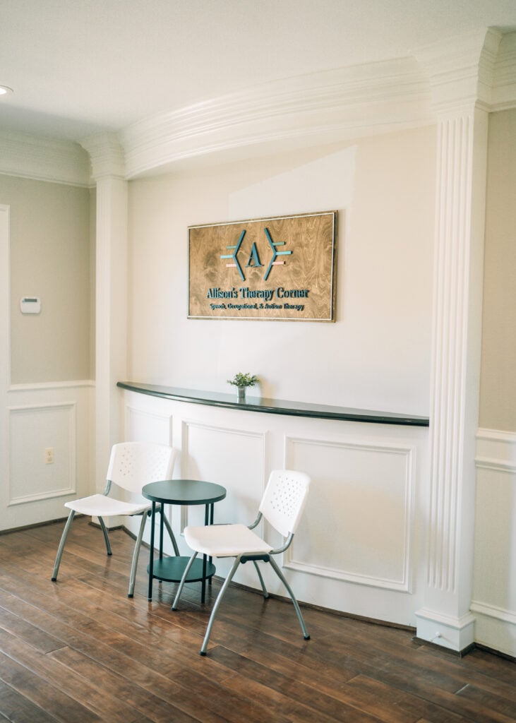 Reception area at Allison’s Therapy Corner with clinic sign and seating for families.
