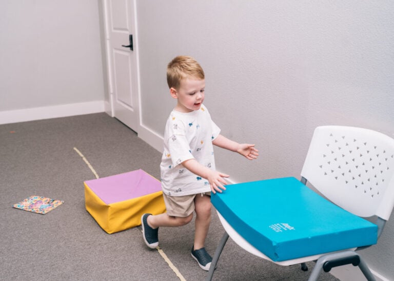 Child practicing balance and coordination during therapy activity.