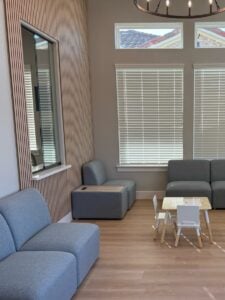 Modern waiting room with seating and child play table in ABA clinic