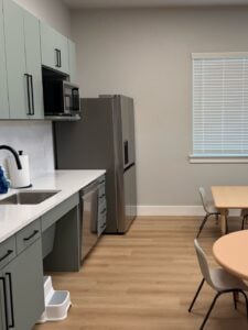 Life skills training room with kitchen setup for ABA therapy in Fort Worth