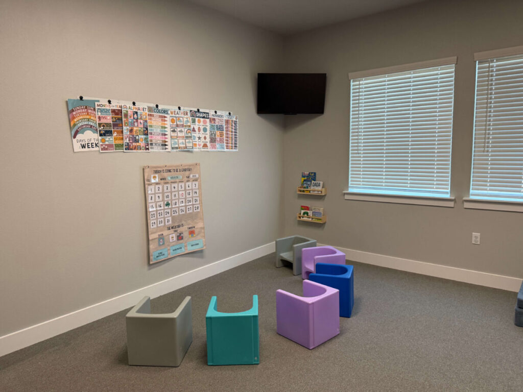 Group learning room with chairs and educational visuals for ABA therapy.