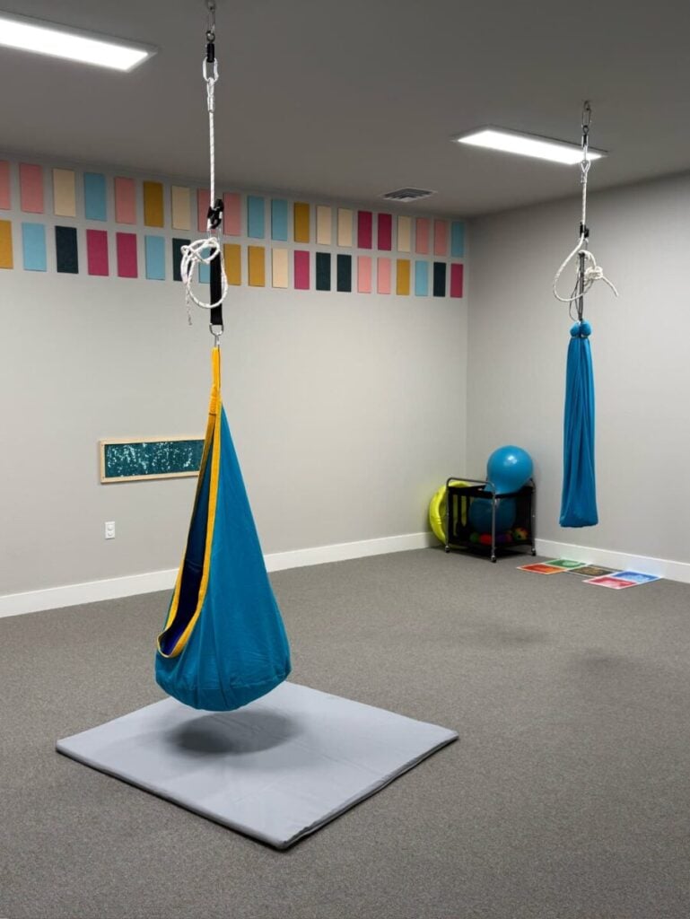 Group learning room with chairs and educational visuals for ABA therapy.