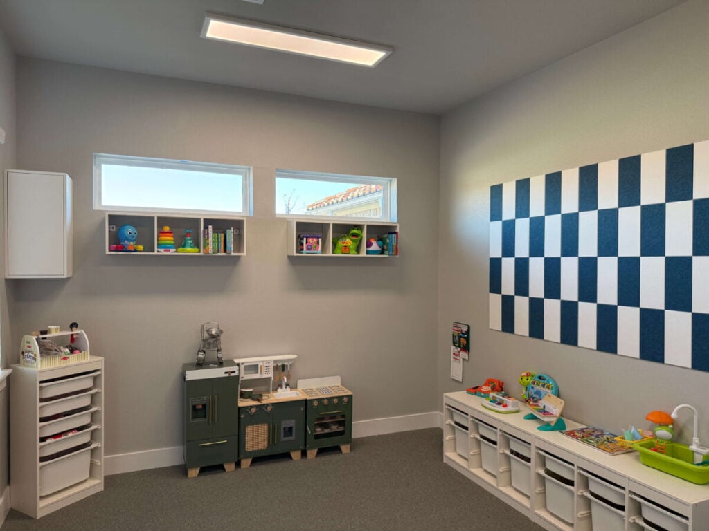 Sensory playroom with toys and shelves used for ABA therapy sessions